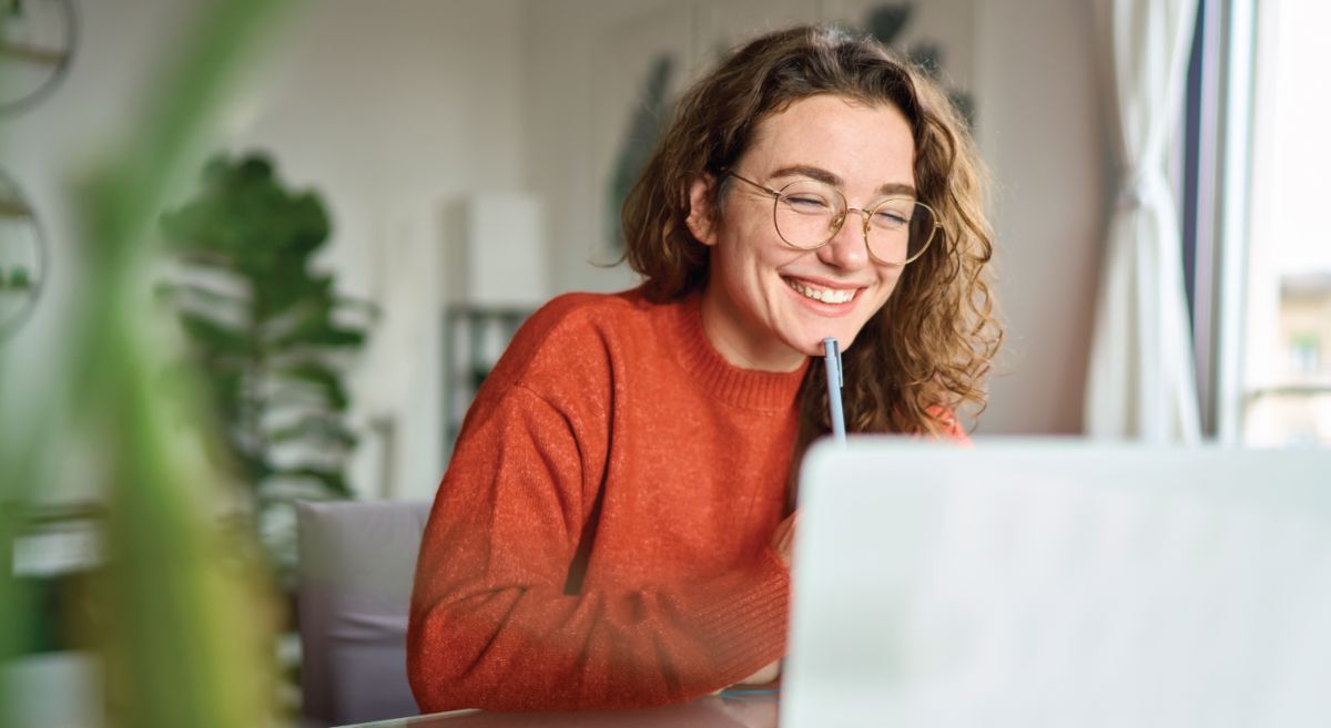 Female smiling looking at laptop